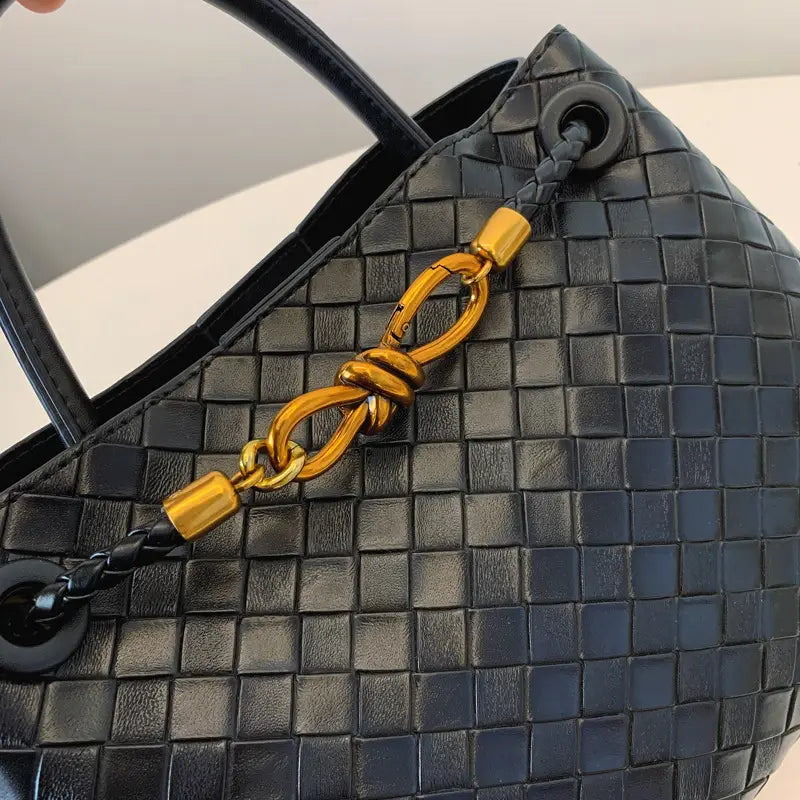 Metal rope buckle woven shoulder bag fashionable versatile retro commuter bag for women.