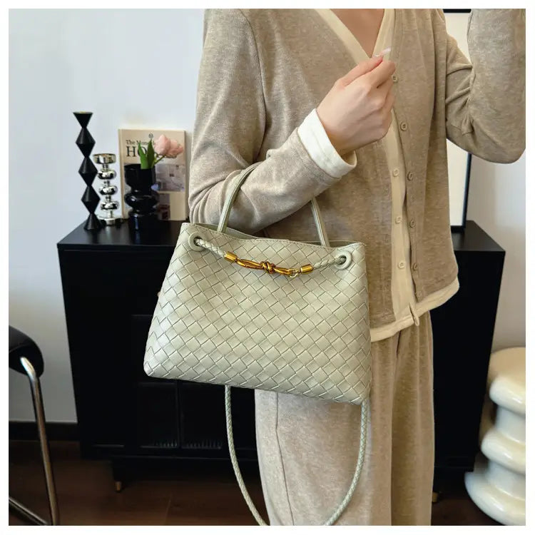 Metal rope buckle woven shoulder bag fashionable versatile retro commuter bag for women.