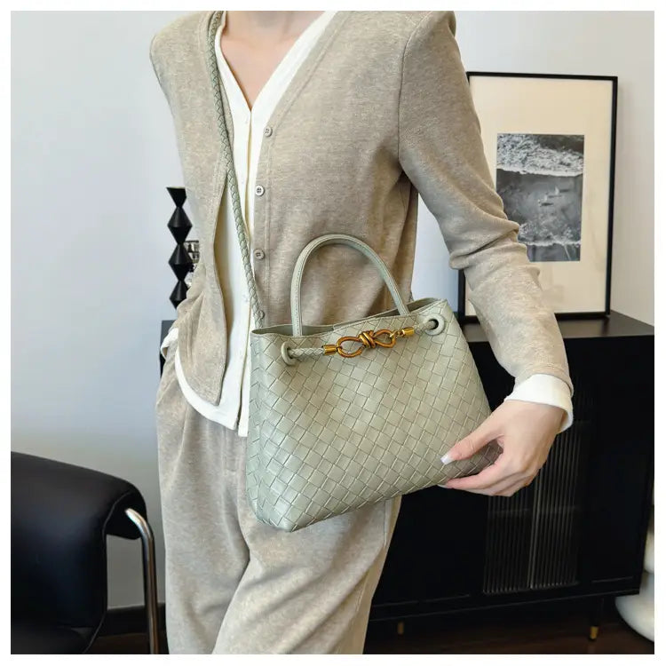 Metal rope buckle woven shoulder bag fashionable versatile retro commuter bag for women.