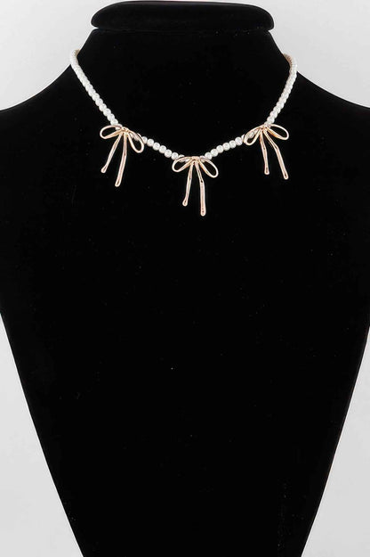 Pearl And Metal Ribbon Charm Necklace