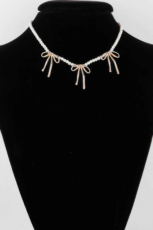 Pearl And Metal Ribbon Charm Necklace