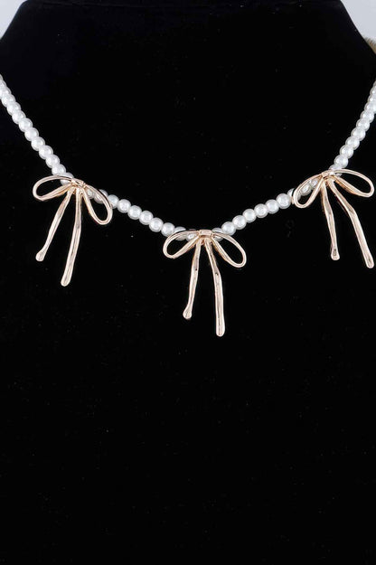 Pearl And Metal Ribbon Charm Necklace