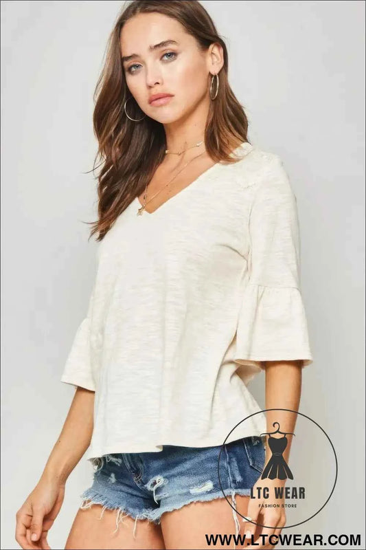 A Knit Top With Deep V Neckline And Yoke Design