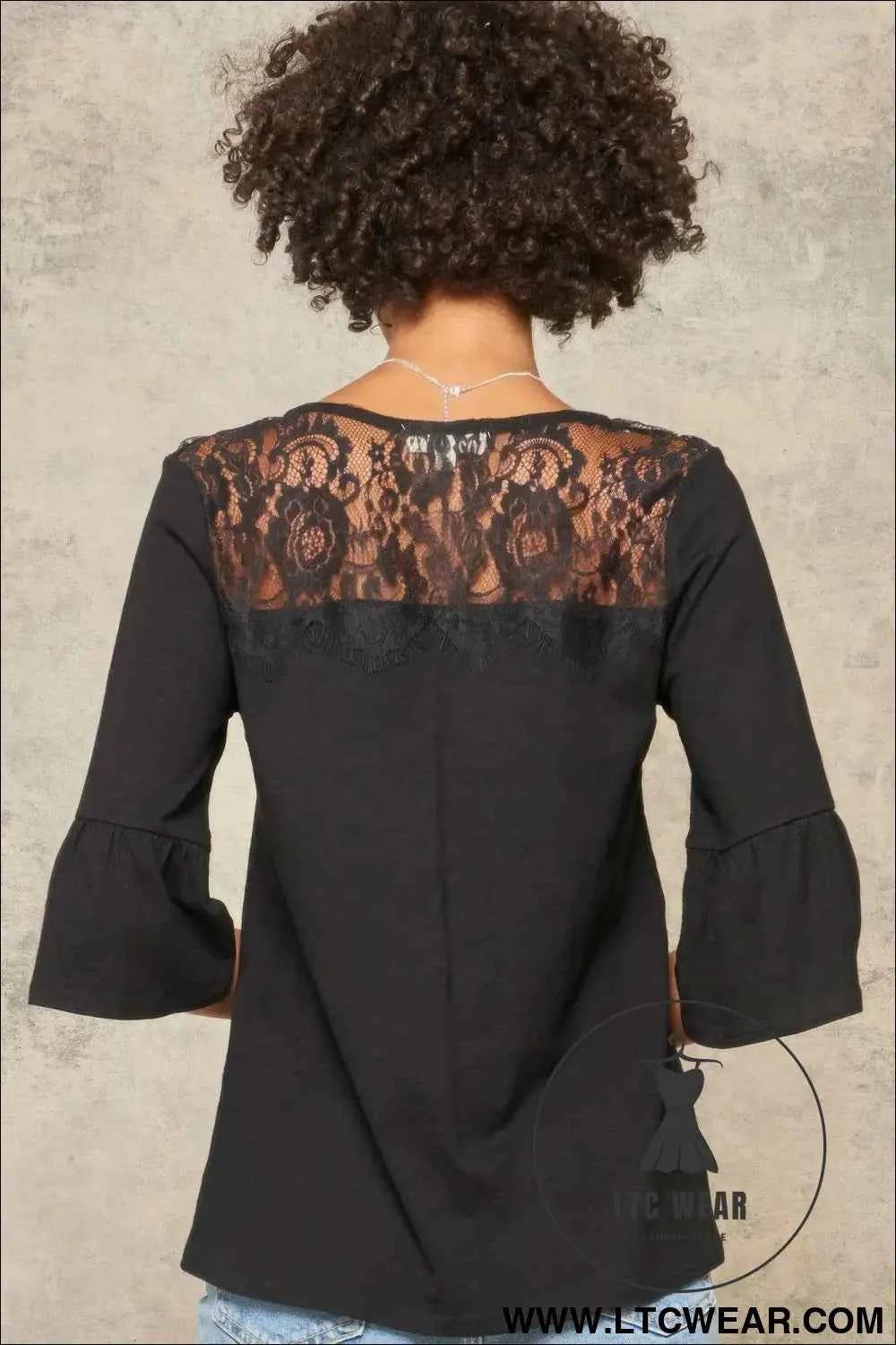 A Knit Top With Deep V Neckline And Yoke Design